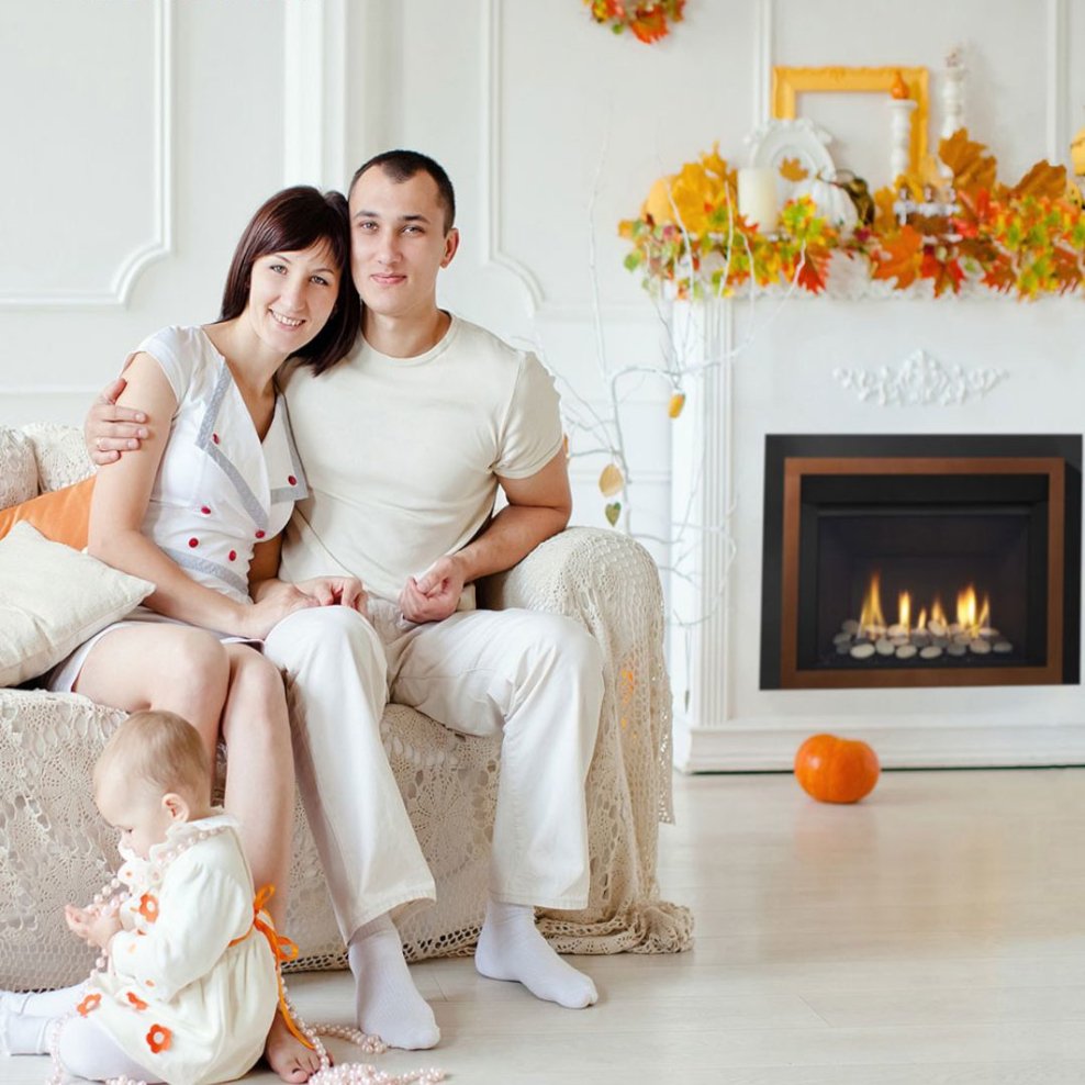 Happy couple and their young daughter posing in their living room