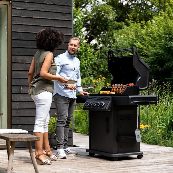 Man and woman chatting while grilling